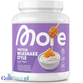 Guiltfree More Nutrition Total Protein o smaku greckiego jogurtu w białym opakowaniu z fioletową etykietą
